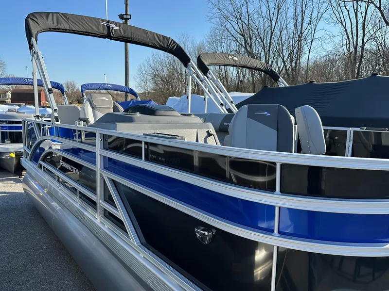 Slide: The Image of 2025 Bennington 188 SF pontoon boat with blue accents and four fishing seats. - 15