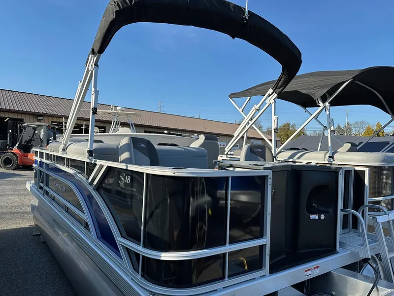 Slide: The Image of 2025 Bennington 188 SF Family pontoon boat with canopy, docked outdoors. - 16