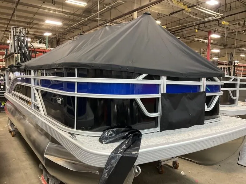 Slide: The Image of 2025 Bennington 188 SF pontoon boat with cover in warehouse setting. - 28