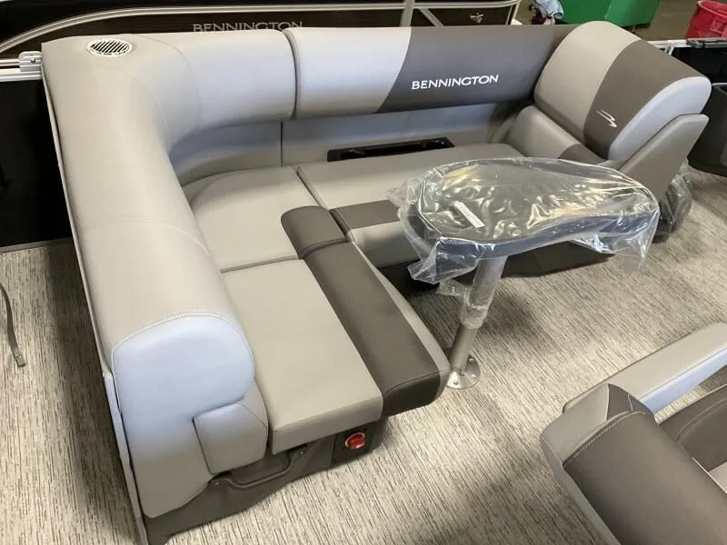 Slide: The Image of 2025 Bennington 188 SF Family boat seating with table, featuring gray and brown upholstery. - 3