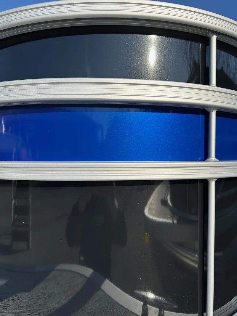 Slide: The Image of Close-up of 2025 Bennington 188 SF Family boat exterior with blue and silver detailing. - 30