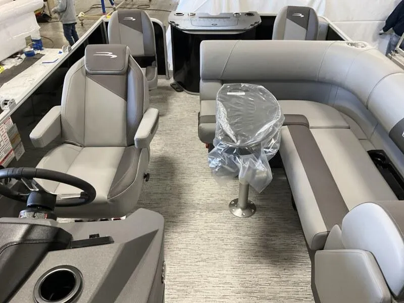 Slide: The Image of 2025 Bennington 188 SF Family boat interior with gray seating and steering console. - 6