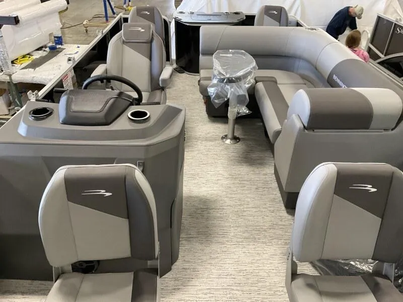 Slide: The Image of 2025 Bennington 188 SF Family boat interior with gray seating and steering console. - 7