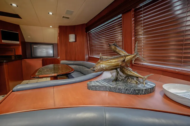Slide: The Image of Luxurious interior of a 1997 Hatteras Sportfish yacht with elegant decor and wooden blinds. - 11
