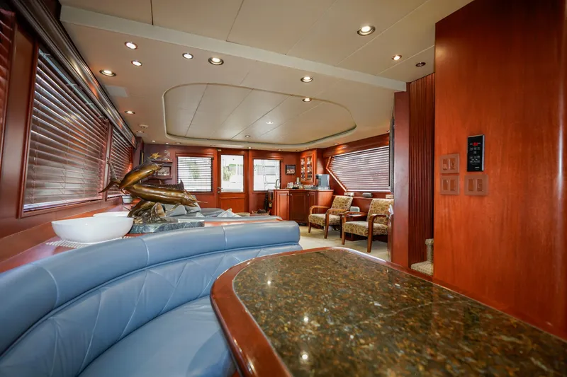 Slide: The Image of Luxurious interior of a 1997 Hatteras Sportfish yacht with elegant wood finishes. - 12