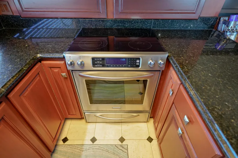 Slide: The Image of Stainless steel oven in a 1997 Hatteras Sportfish yacht kitchen with granite countertops. - 19