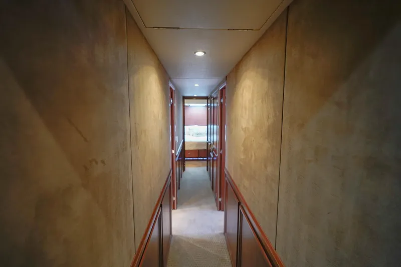 Slide: The Image of Narrow hallway inside a 1997 Hatteras Sportfish yacht, leading to a bedroom. - 20