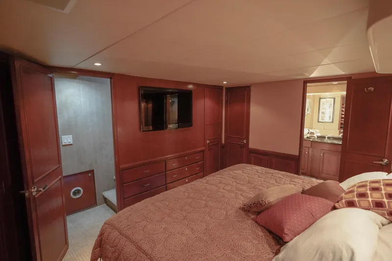 Slide: The Image of Luxurious bedroom interior of 1997 Hatteras Sportfish yacht with TV and ensuite bathroom. - 23