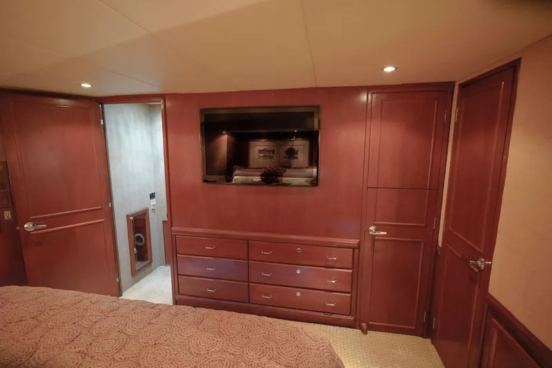 Slide: The Image of 1997 Hatteras Sportfish bedroom with wooden cabinetry and built-in TV. - 24