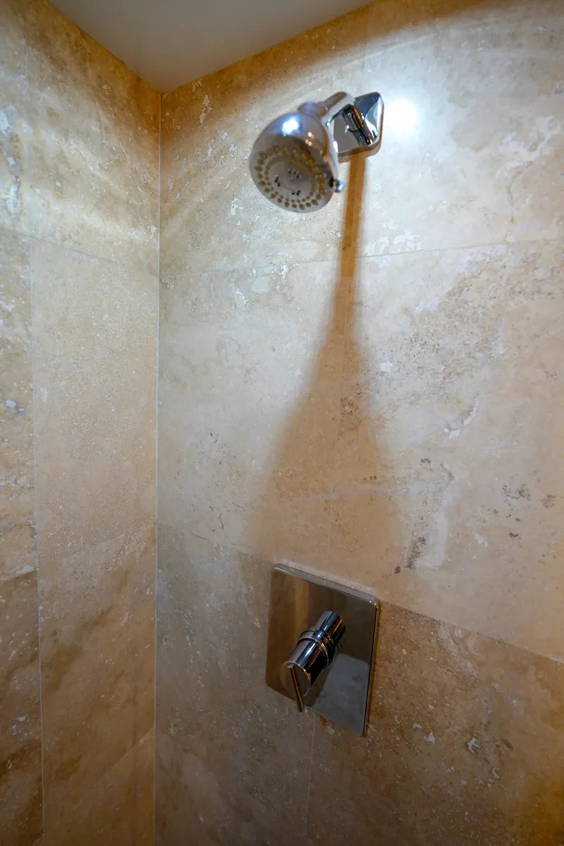Slide: The Image of Shower in 1997 Hatteras Sportfish yacht with beige tiled walls. - 29