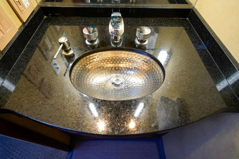 Slide: The Image of 1997 Hatteras Sportfish bathroom sink with black granite countertop. - 40