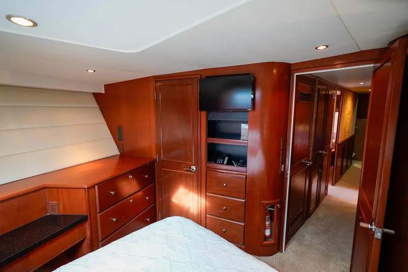 Slide: The Image of Luxurious cabin interior of a 1997 Hatteras Sportfish yacht with wood cabinetry. - 42