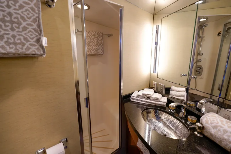 Slide: The Image of Luxurious bathroom in a 1997 Hatteras Sportfish yacht with modern fixtures and shower. - 44