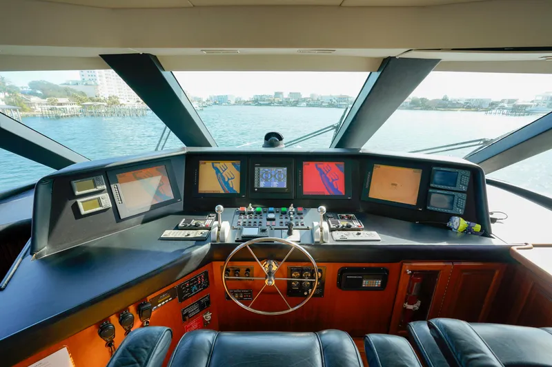 Slide: The Image of 1997 Hatteras Sportfish yacht helm with navigation screens and controls. - 48