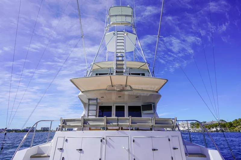 Slide: The Image of 1997 Hatteras Sportfish yacht with a clear blue sky background. - 5
