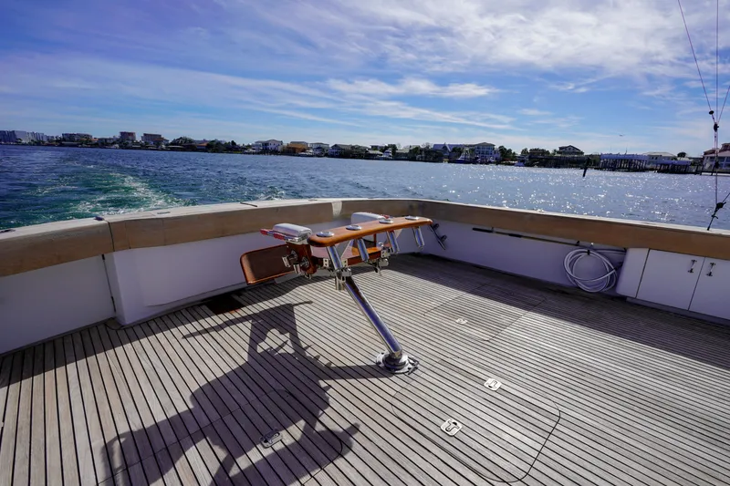 Slide: The Image of 1997 Hatteras Sportfish boat deck with ocean view and fishing chair. - 7
