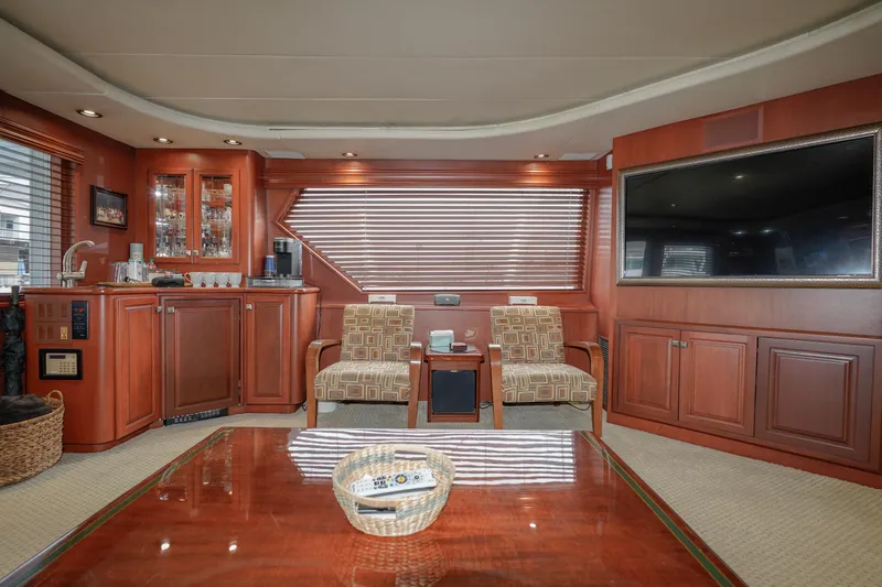 Slide: The Image of Luxurious interior of a 1997 Hatteras Sportfish yacht with wood finishes and modern amenities. - 9