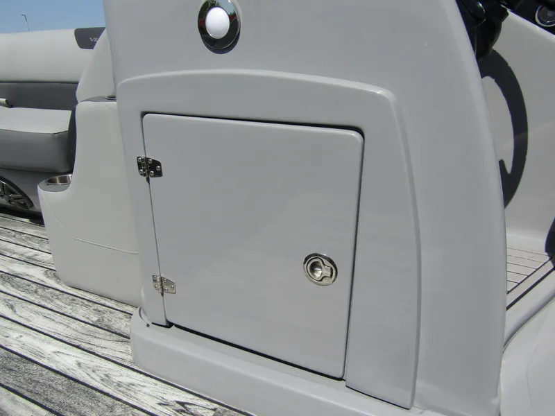 Slide: The Image of 2024 Veranda RELAX VR25RFL boat console with storage compartment on wooden deck. - 15