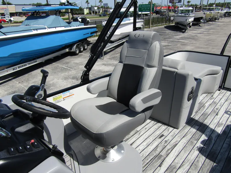 Slide: The Image of 2024 Veranda RELAX VR25RFL boat interior with captain's chair and steering wheel. - 17