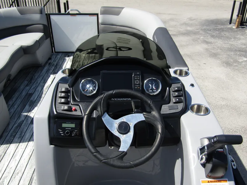 Slide: The Image of 2024 Veranda RELAX VR25RFL boat dashboard with steering wheel and control panel. - 18