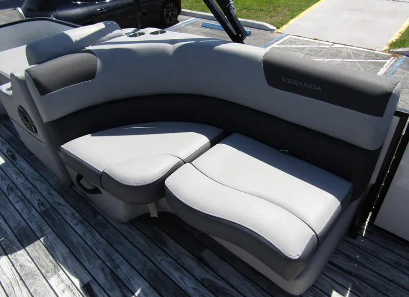 Slide: The Image of 2024 Veranda RELAX VR25RFL boat seating, gray upholstery, on wooden deck. - 24