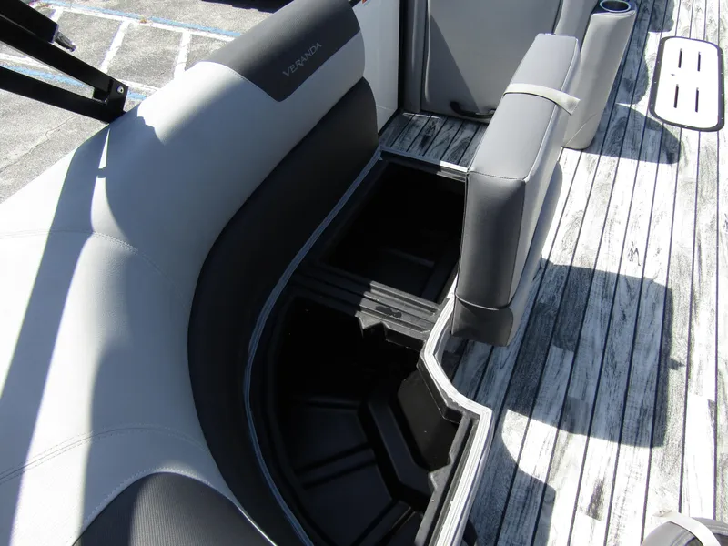 Slide: The Image of 2024 Veranda RELAX VR25RFL boat interior with open storage compartment and sleek seating. - 25
