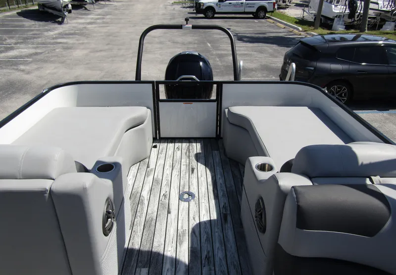 Slide: The Image of 2024 Veranda RELAX VR25RFL pontoon boat interior with gray seating and wood-style flooring. - 26