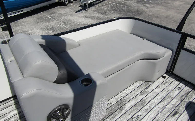 Slide: The Image of 2024 Veranda RELAX VR25RFL pontoon boat with gray seating and cup holder on deck. - 29