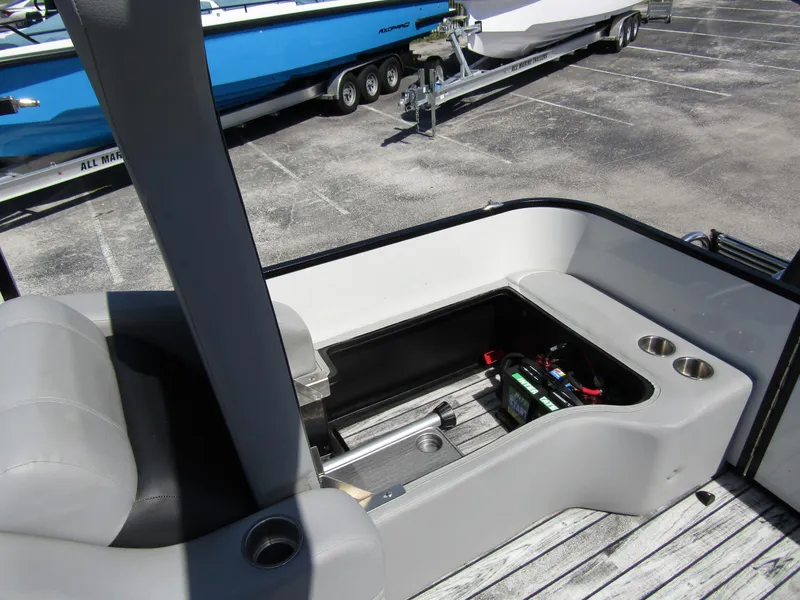 Slide: The Image of 2024 Veranda RELAX VR25RFL boat interior with open storage compartment and cup holders. - 30