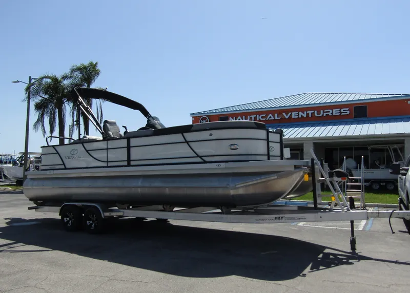 Slide: The Image of 2024 Veranda RELAX VR25RFL pontoon boat on trailer at Nautical Ventures dealership. - 5