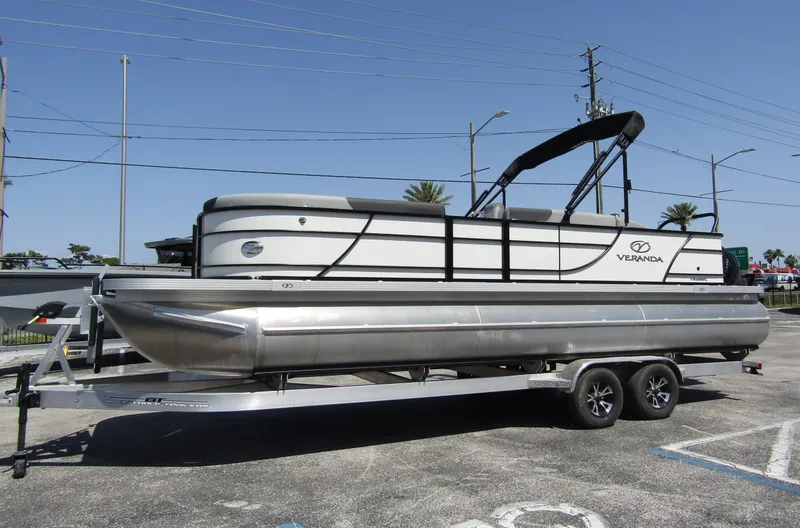 Slide: The Image of 2024 Veranda RELAX VR25RFL pontoon boat on a trailer in a parking lot. - 6