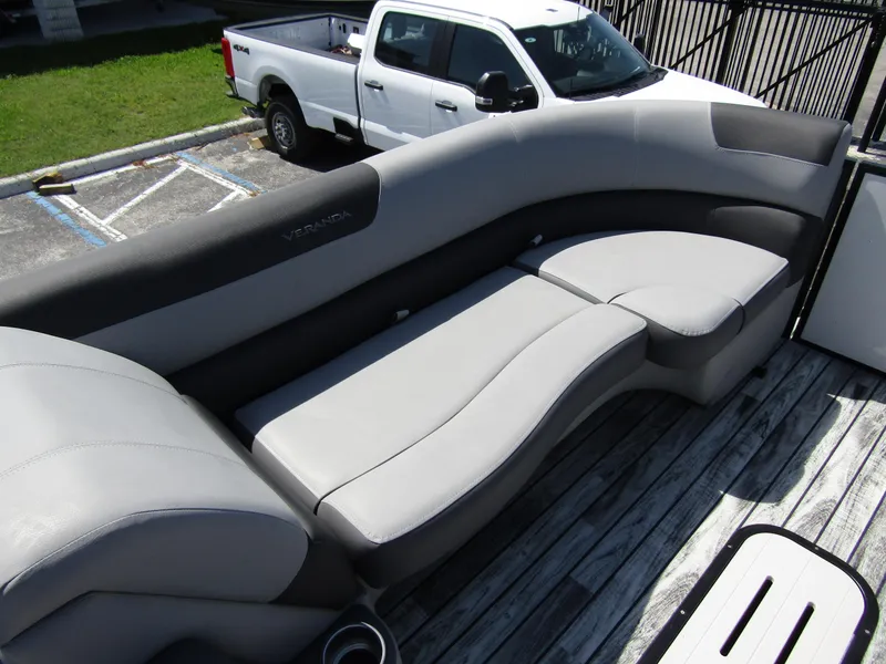 Slide: The Image of 2024 Veranda RELAX VR25RFL boat with luxurious seating, parked near a white truck. - 9