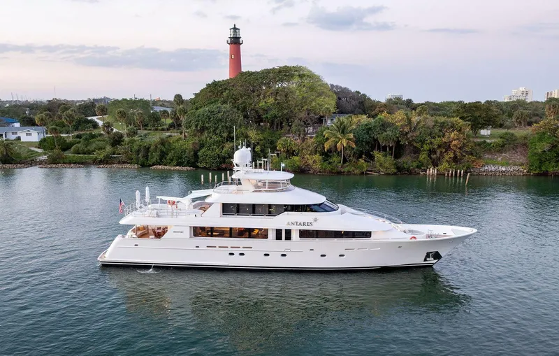 Slide: The Image of Luxury 2008 Westport 130 yacht cruising near a scenic lighthouse. - 10