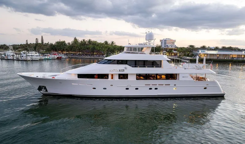 Slide: The Image of Luxury 2008 Westport 130 yacht docked in a serene marina at sunset. - 12