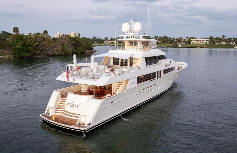 Slide: The Image of Luxury 2008 Westport 130 yacht cruising on a serene waterway. - 14