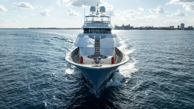 Slide: The Image of 2008 Westport 130 yacht cruising on open water under a sunny sky. - 17