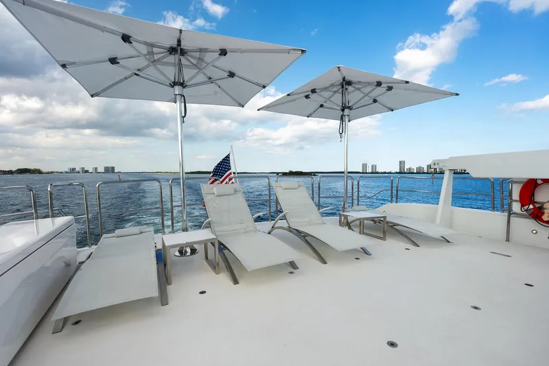 Slide: The Image of Luxury deck of 2008 Westport 130 yacht with sun loungers and umbrellas. - 21