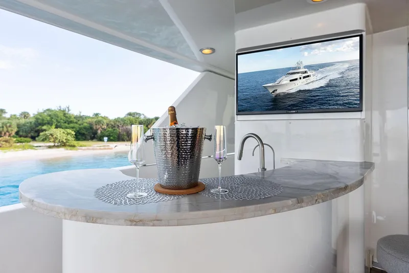 Slide: The Image of Luxury yacht bar area with champagne, glasses, and ocean view; Westport 130, 2008 model. - 23