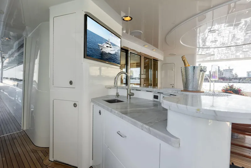 Slide: The Image of Luxurious 2008 Westport 130 yacht interior with marble countertops and a mounted TV. - 26