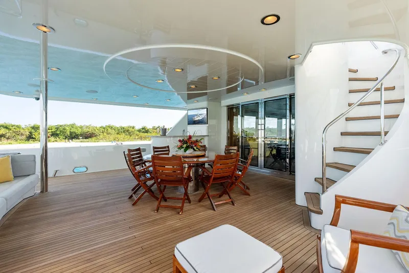 Slide: The Image of Luxurious outdoor deck on a 2008 Westport 130 yacht with wooden furniture. - 35