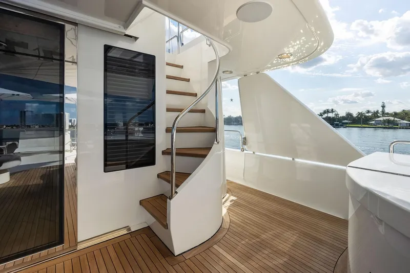 Slide: The Image of Luxury yacht Westport 130, 2008 model, featuring elegant wooden deck and spiral staircase. - 36