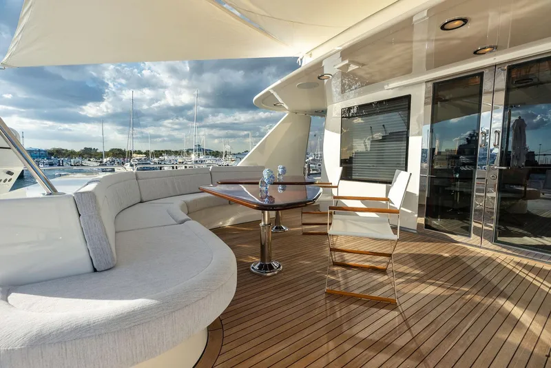 Slide: The Image of Luxurious deck of 2008 Westport 130 yacht with seating and table, docked at marina. - 40