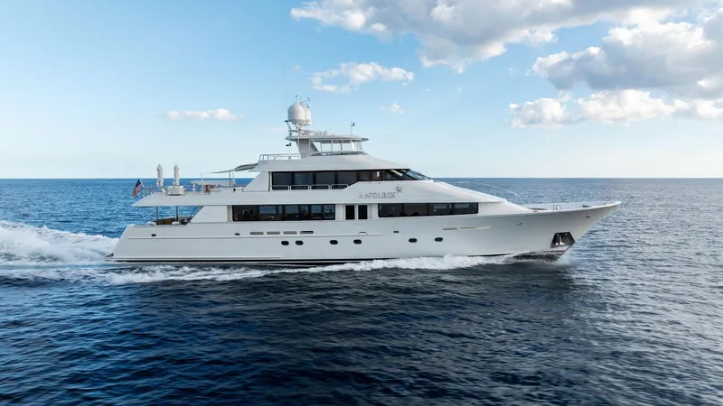 Slide: The Image of 2008 Westport 130 yacht cruising on open water under a partly cloudy sky. - 8