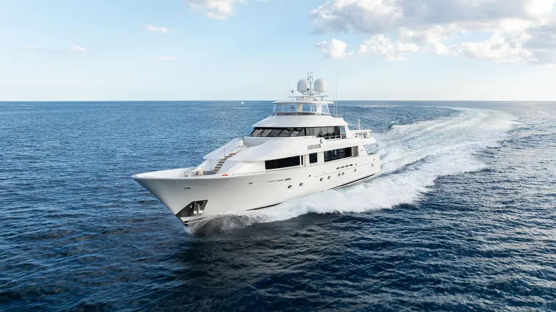 Slide: The Image of 2008 Westport 130 yacht cruising on open sea under a partly cloudy sky. - 9
