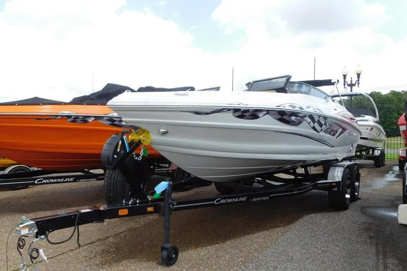 The Image of 2024 Crownline 220 SS LPX boat in showroom, featuring sleek design and checkered graphics. - 0