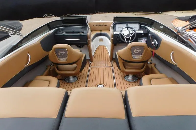 Slide: The Image of 2024 Crownline 220 SS LPX boat interior with tan seating and speakers. - 11