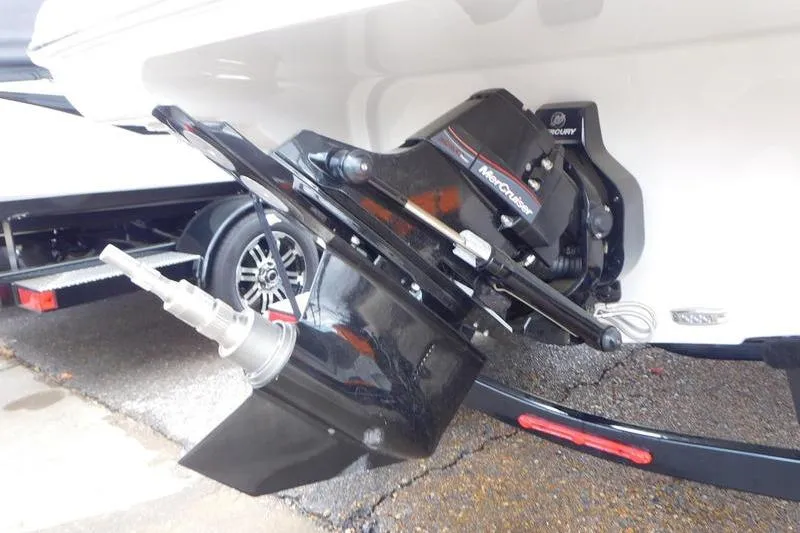 Slide: The Image of 2024 Crownline 220 SS LPX boat interior with open storage compartment and tan seating. - 12