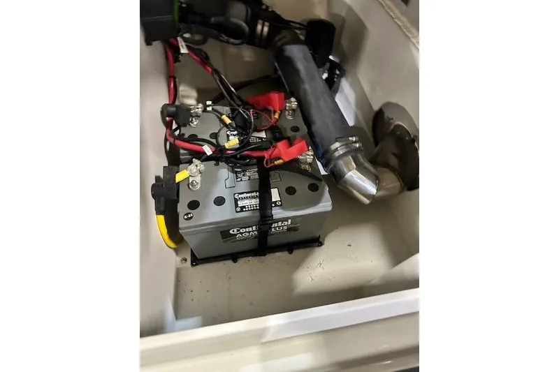 Slide: The Image of 2024 Crownline 220 SS LPX boat battery compartment with wiring and components. - 14