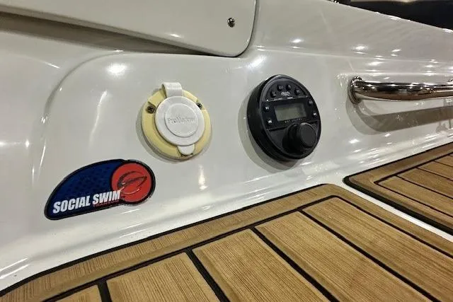 Slide: The Image of 2024 Crownline 220 SS LPX boat deck with controls and "Social Swim" sticker. - 17