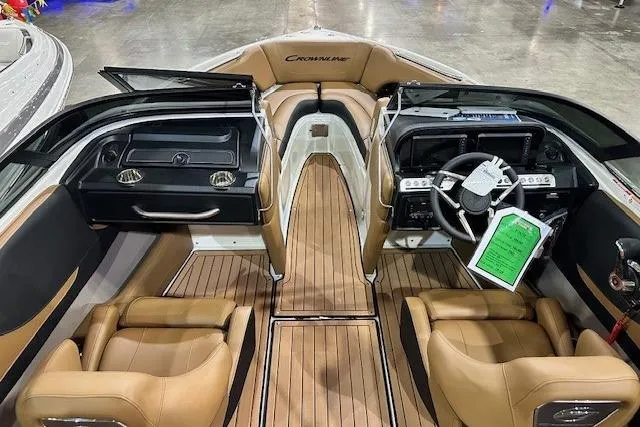 Slide: The Image of 2024 Crownline 220 SS LPX boat interior with tan leather seats and modern dashboard. - 19